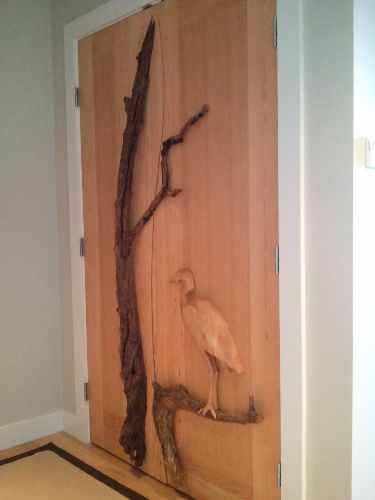 Don Bastian Hand carved Heron sitting on a branch 